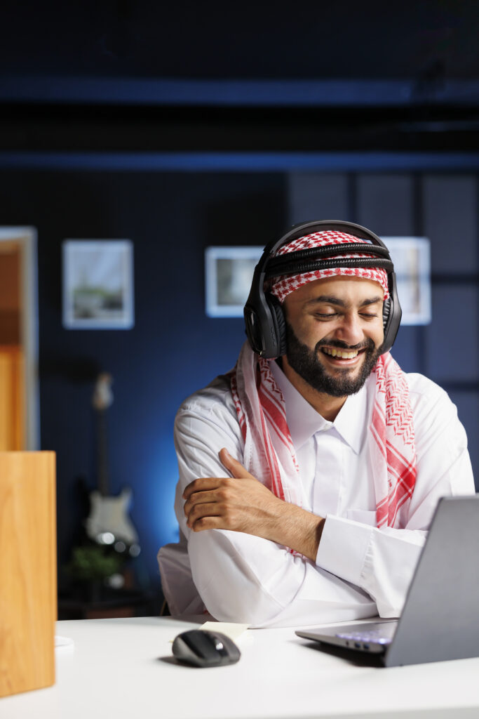 A laptop displaying an online Quran class website with a teacher and students engaged in learning.